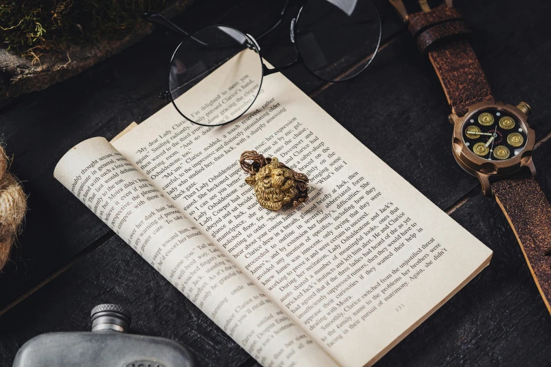 an open book on top of a table with glasses