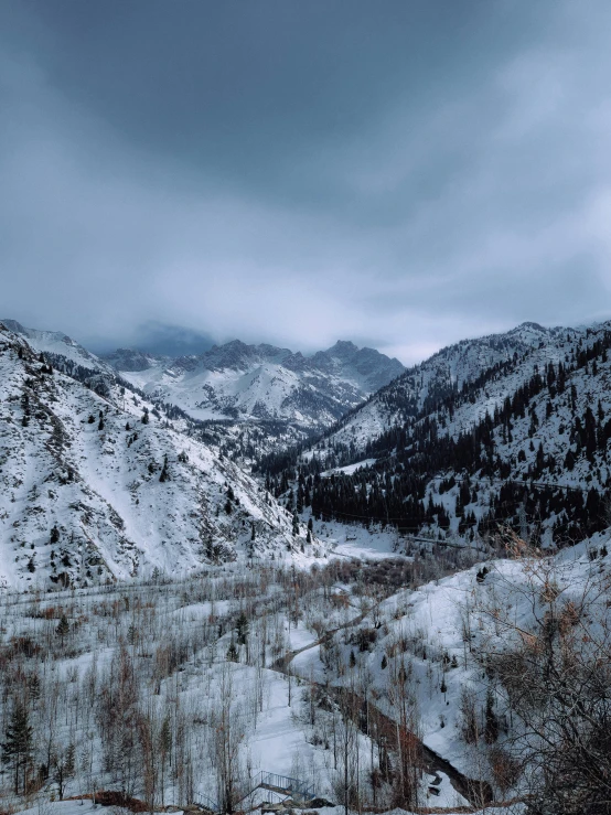 a large snowy mountain with a lone person walking on it