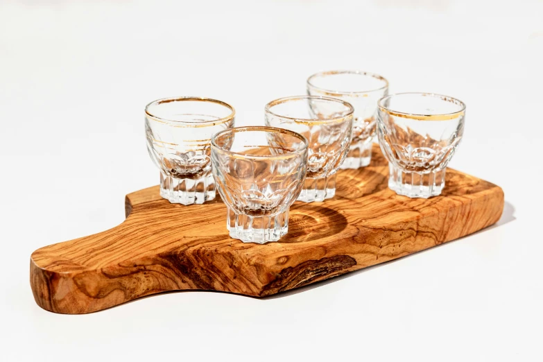 several glasses are on a wooden stand in the middle of the image