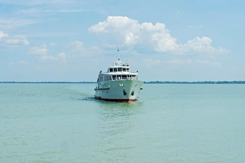 the boat is traveling on the water on a sunny day