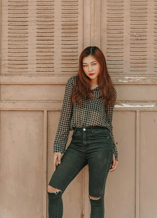 a girl in a on up shirt poses for the camera