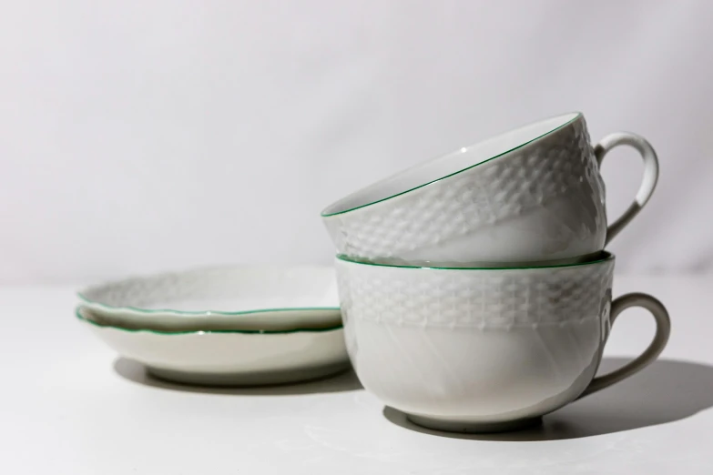 four bowls with green trim sit in the sun