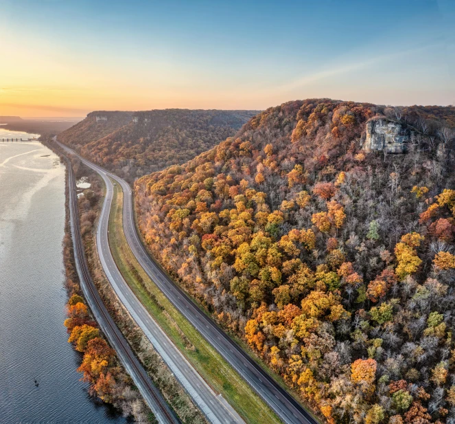 a road running alongside the water, in an aerial po