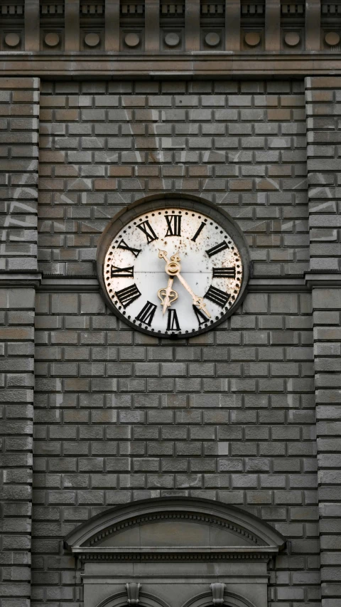 a clock sitting on the side of a brick wall