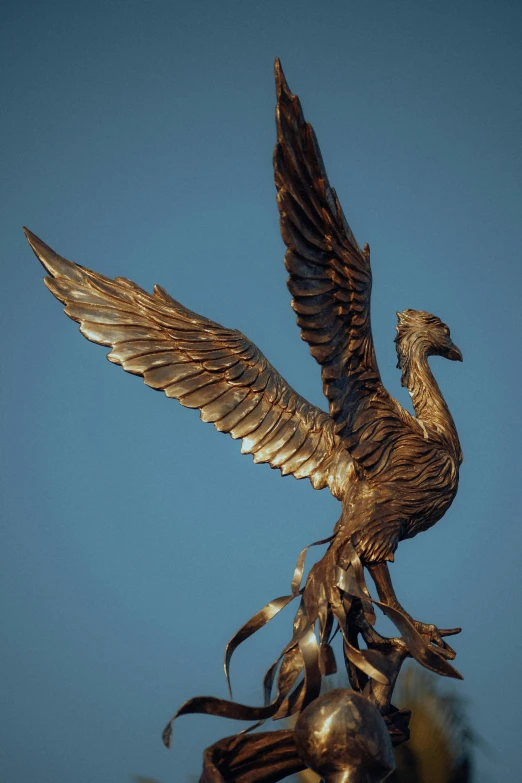 a statue of a bird with outstretched wings