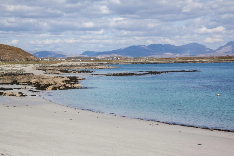 a beach is seen in this image, and is looking out over the water