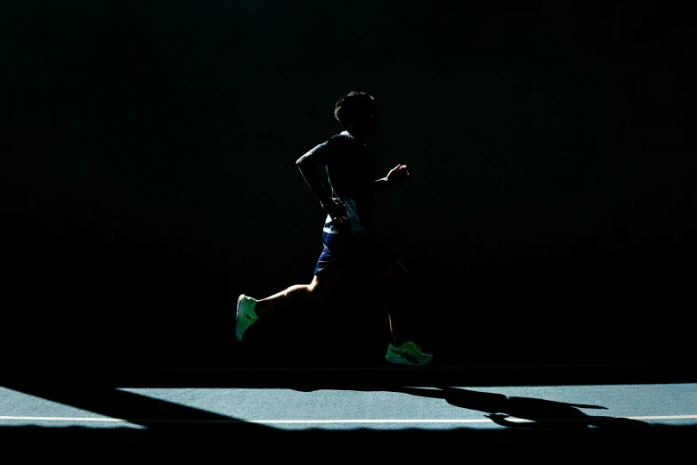 silhouette of a runner running in the dark
