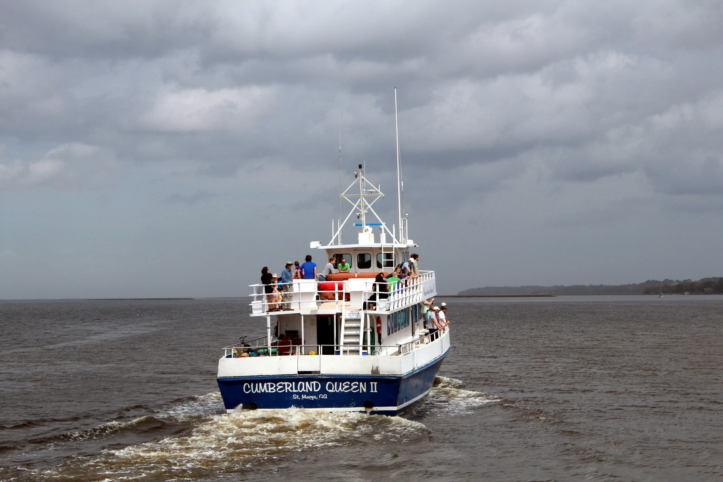 a boat sailing along the side of the water