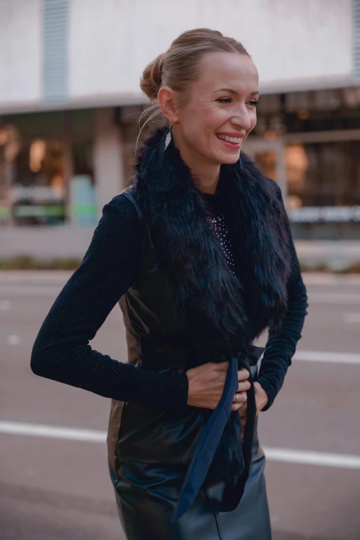 woman with blue tie in front of building