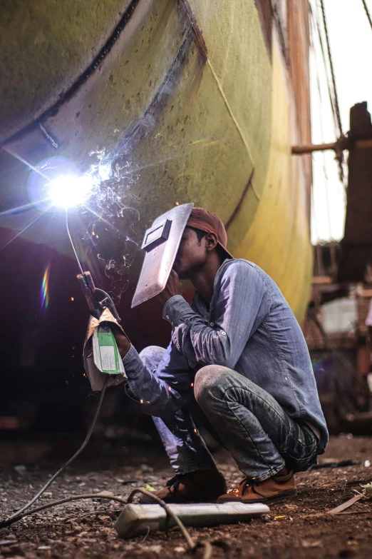 there is a man that is welding soing