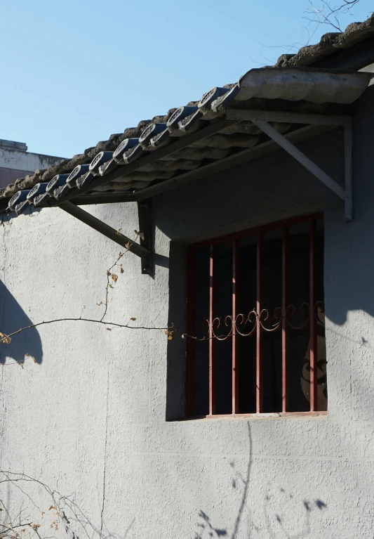 a window and railing against a gray wall