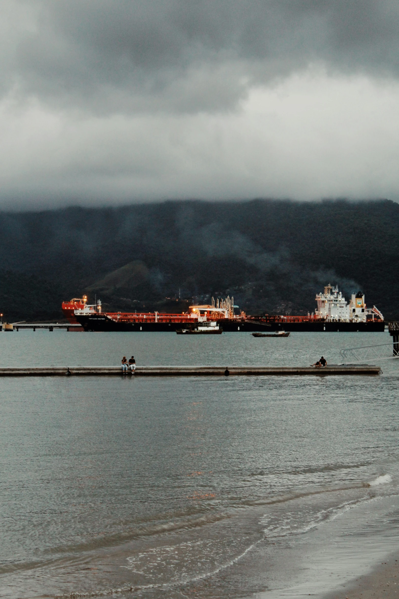 a large cargo ship floating over a beach