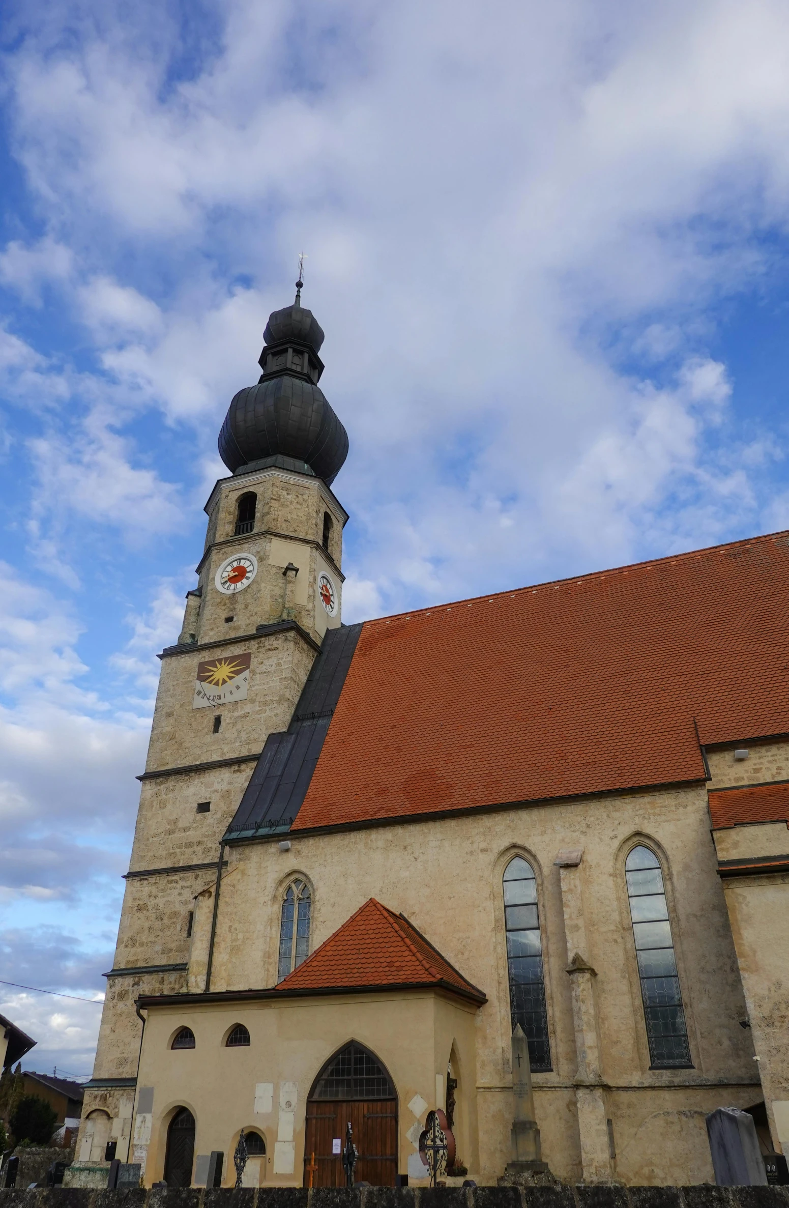 a view of a large cathedral under a cloudy sky