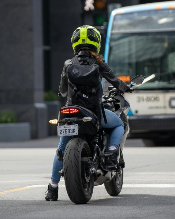 the woman is riding her motorcycle on the street