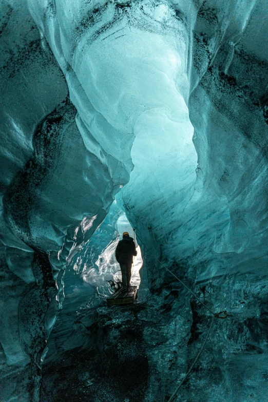 the man is standing in the middle of a very small cave