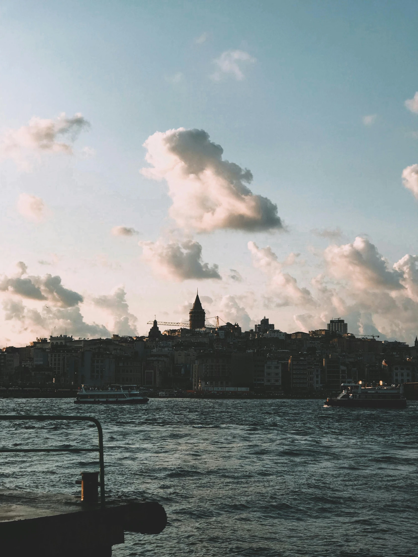 a body of water with clouds in the background