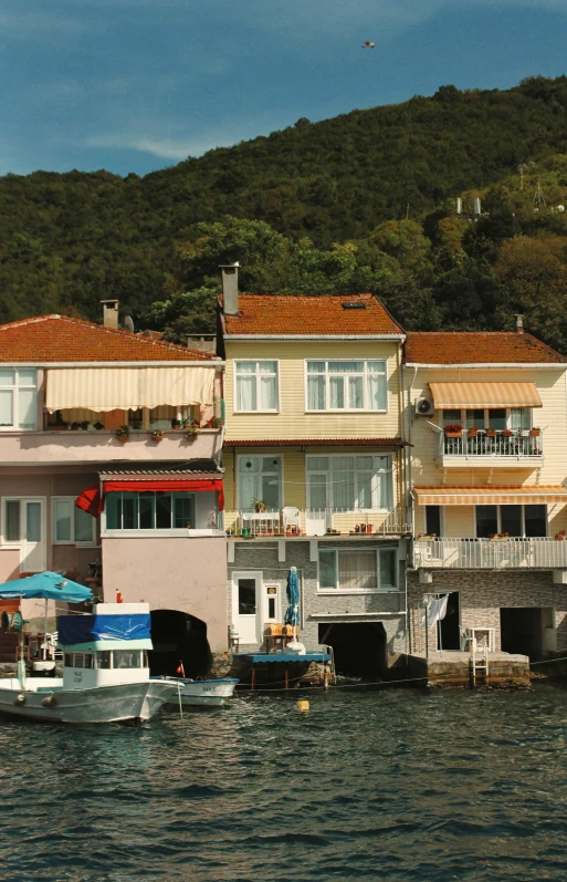 there are several boats in the water beside a house