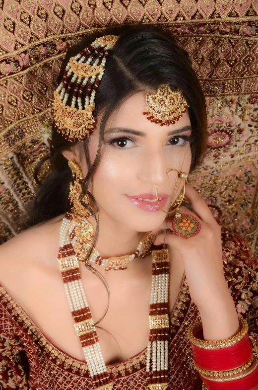 a young woman with makeup and jewelry in her hands