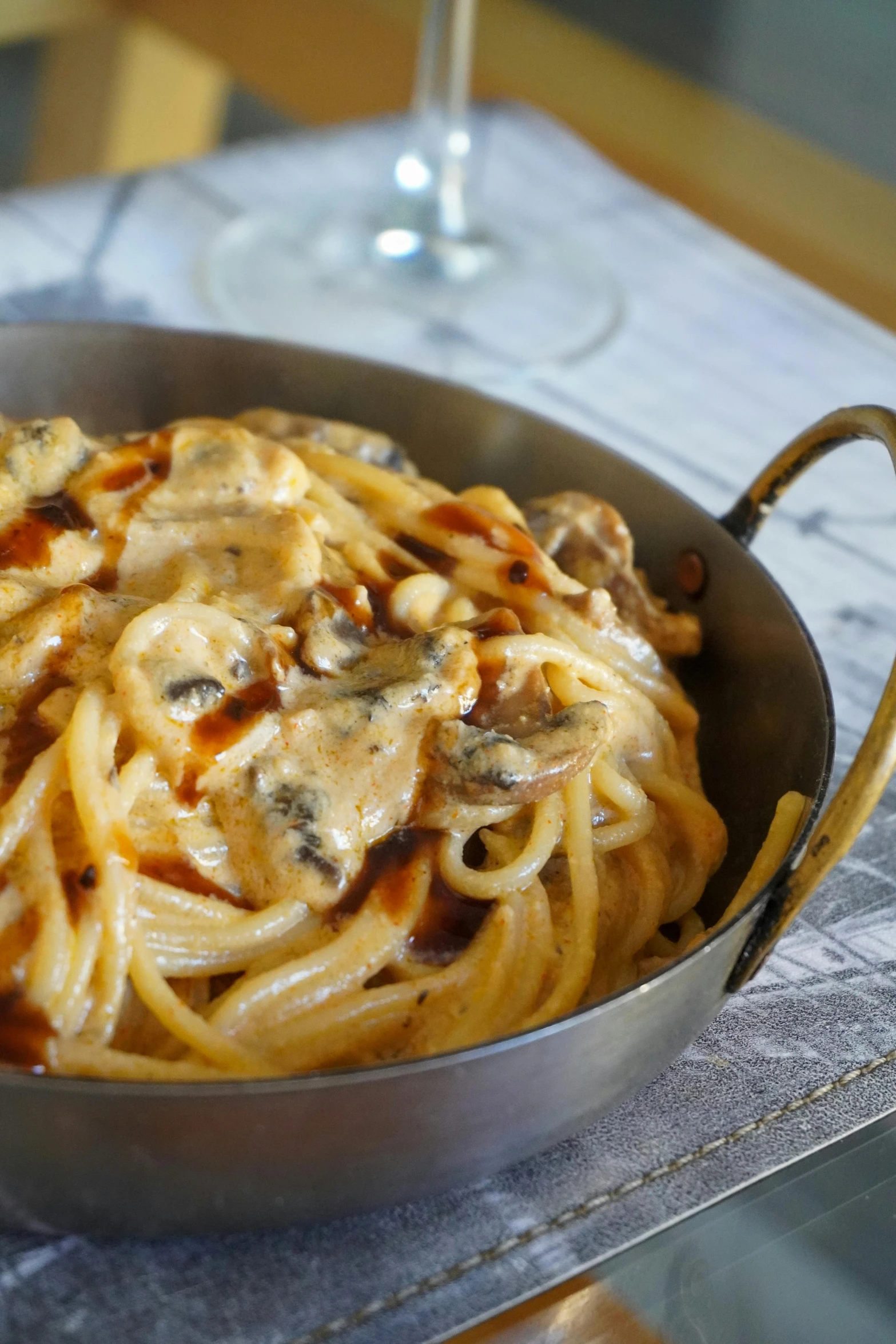 a bowl filled with pasta and meat covered in sauce