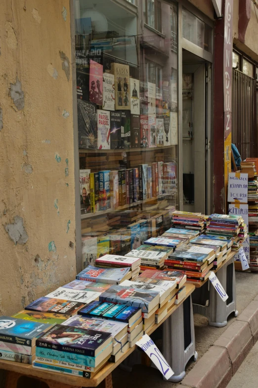 books are placed out on the sidewalk in front of a bookstore