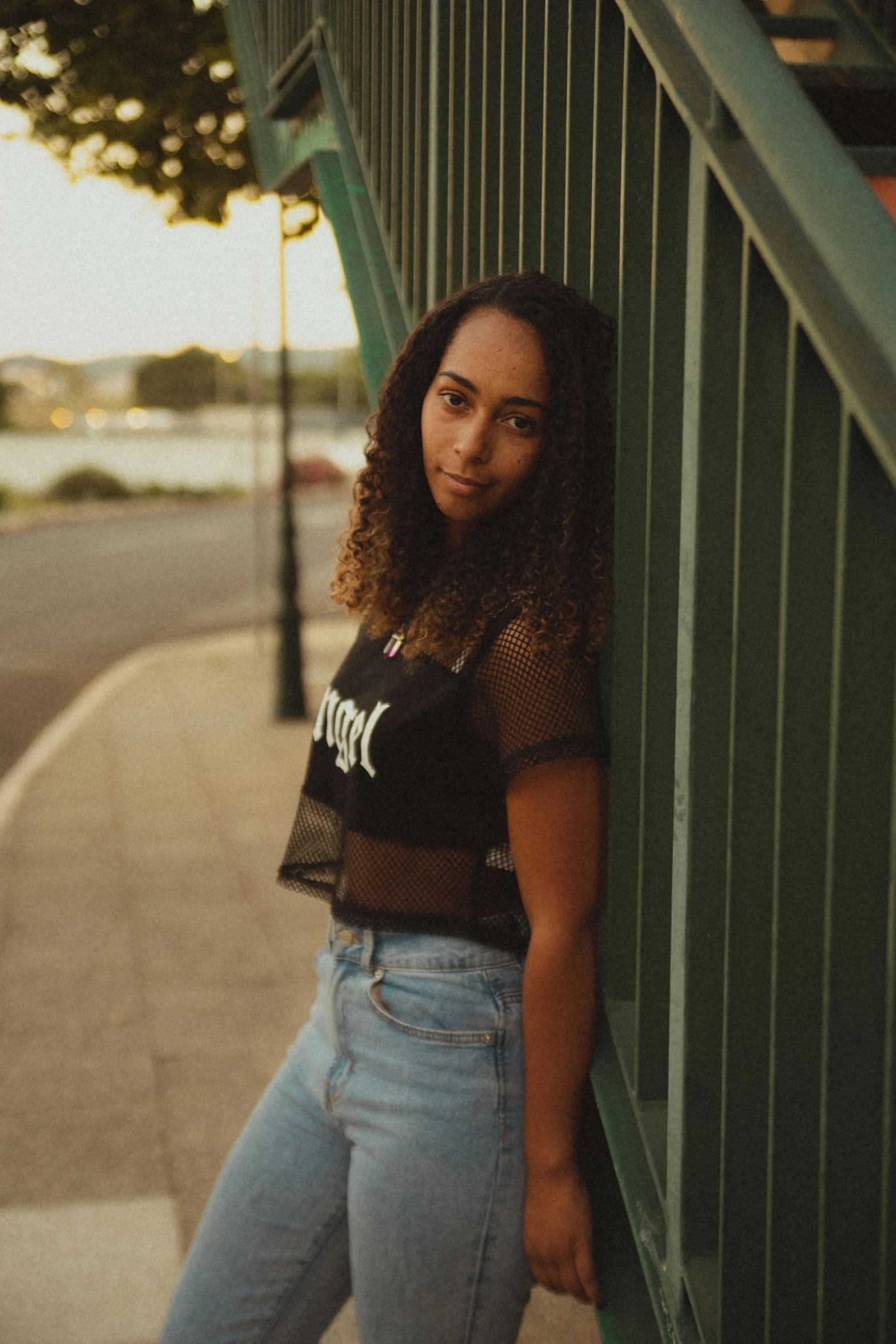 a woman leaning against the wall outside