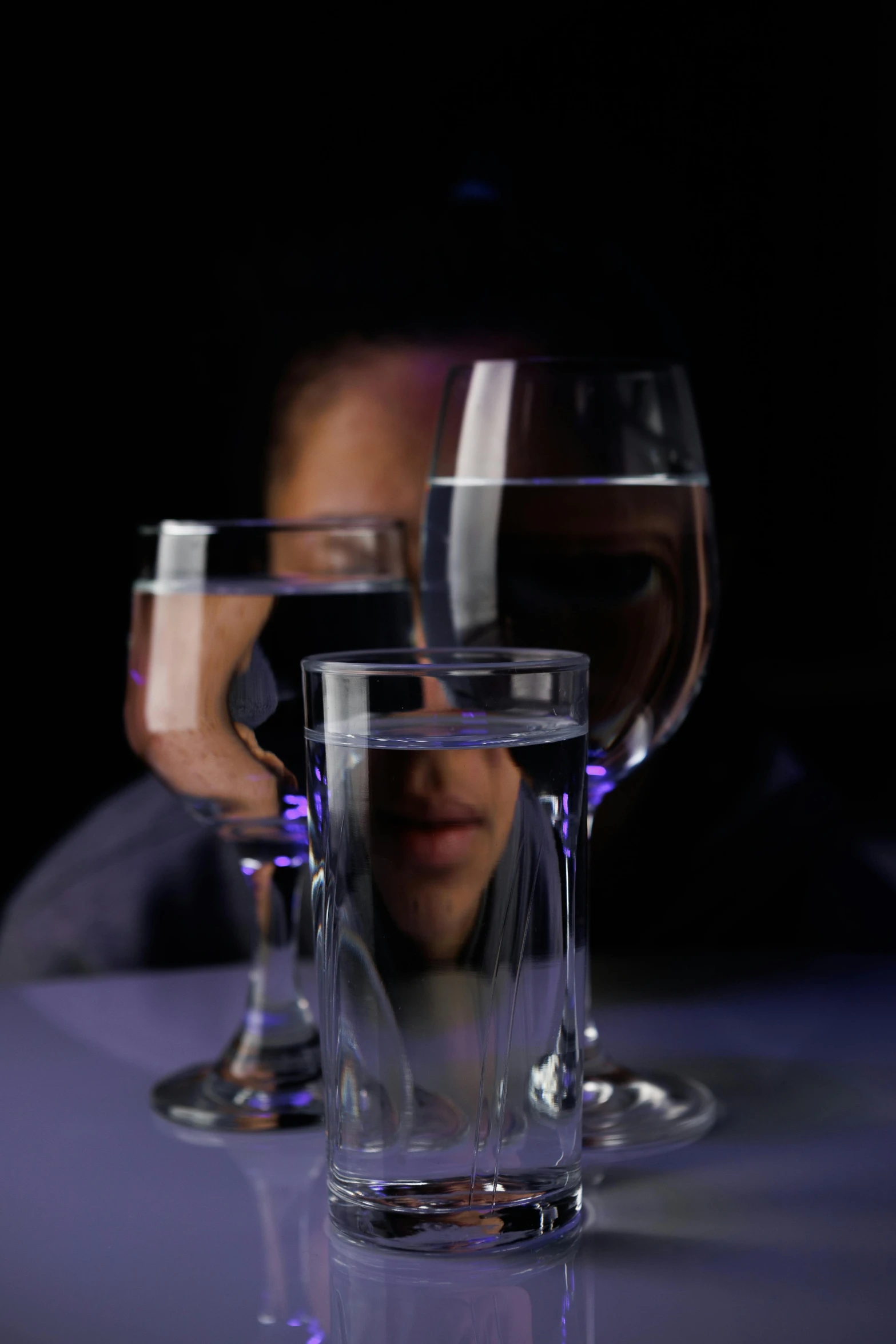 there are two glasses on the table with a person