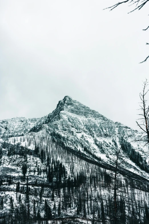 the top of a mountain is surrounded by snow