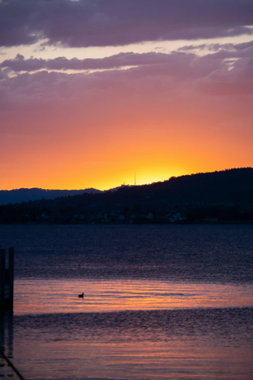 a picture taken at sunrise with mountains in the background