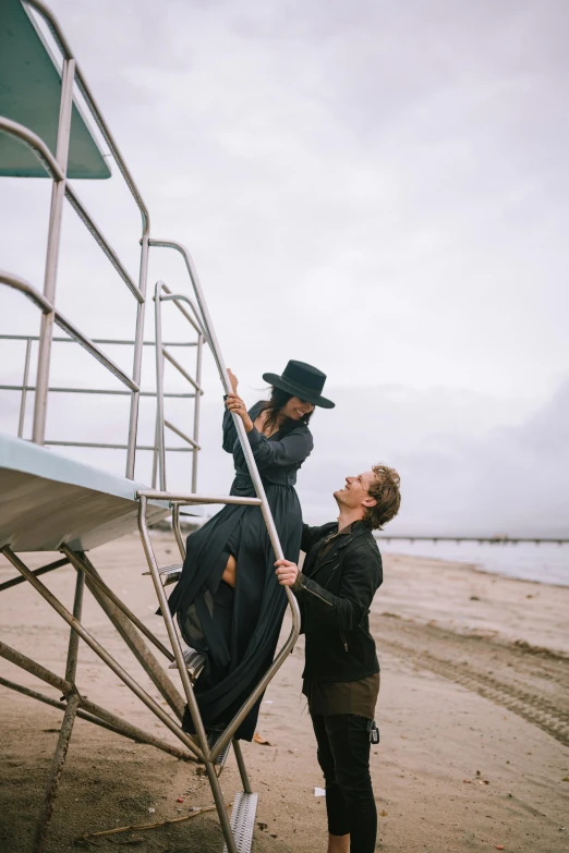 two people are climbing up stairs to an airplane