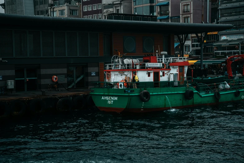 a boat is docked next to a building