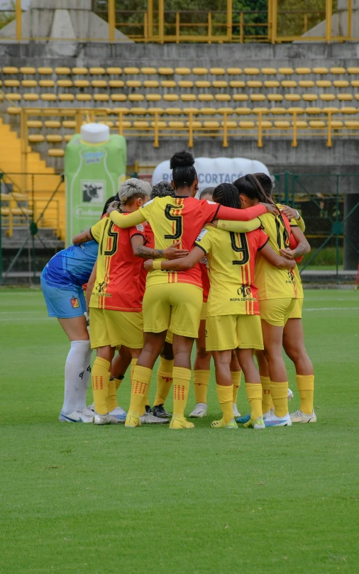 a group of soccer players huddle together during a game