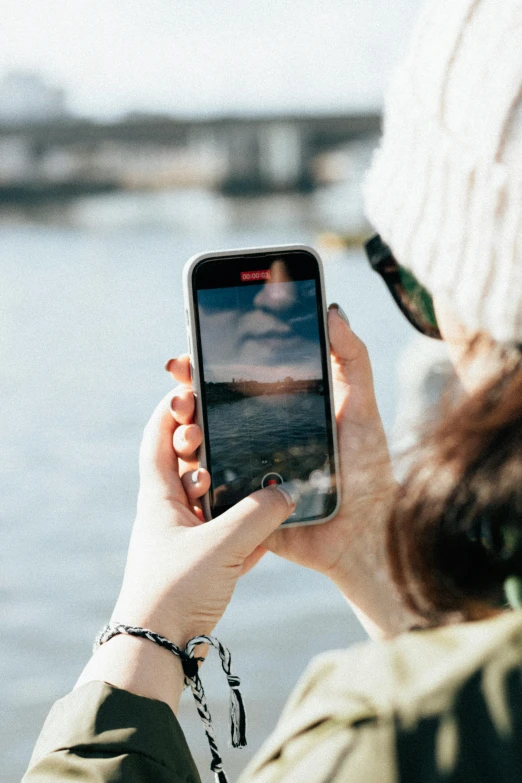 a woman with a cell phone and a white hat