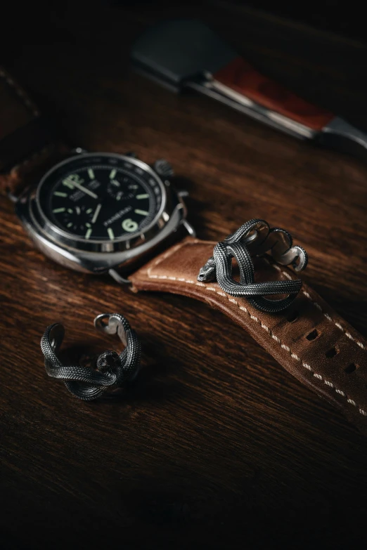 a watch and some leather cuffs on a table