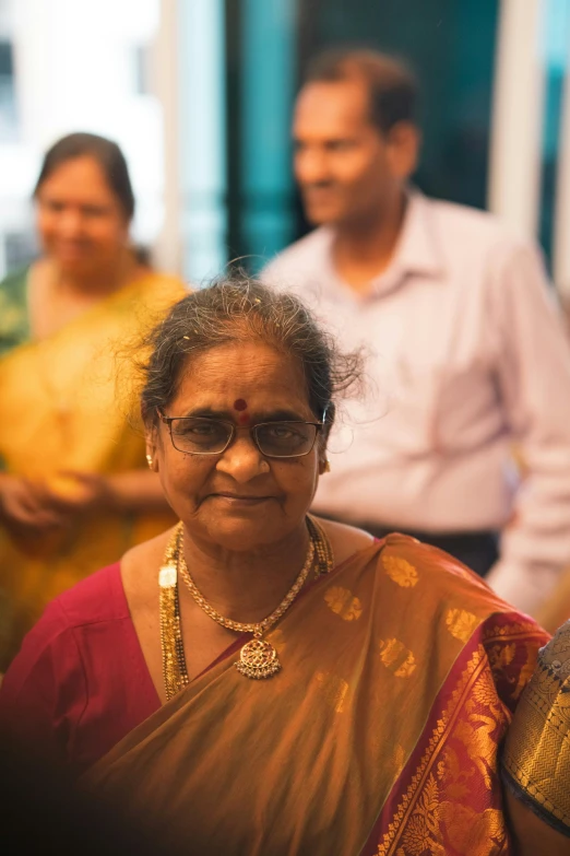 the woman is in sari with her family in the background