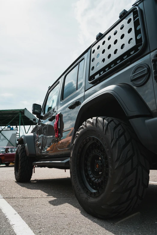 the large jeep is parked near the structure