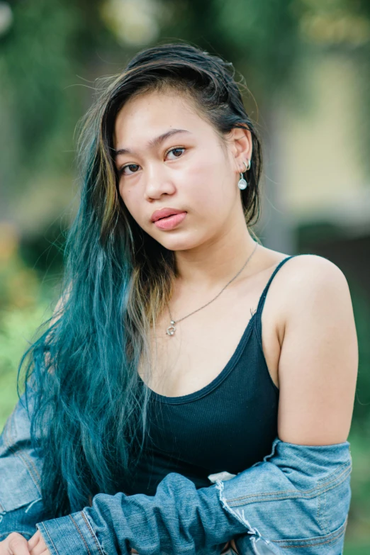young woman with green hair posing for a portrait