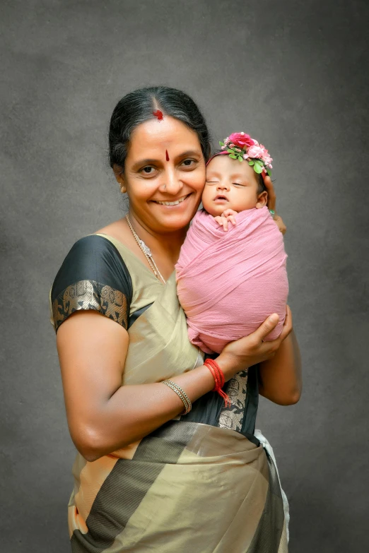 an indian woman holding a baby in her arms