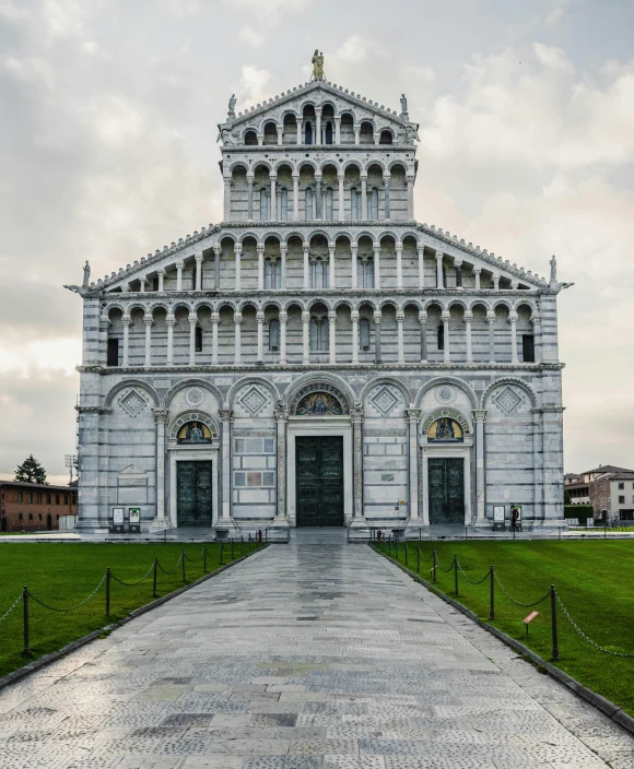 a very tall white church with the top part of it covered in arches