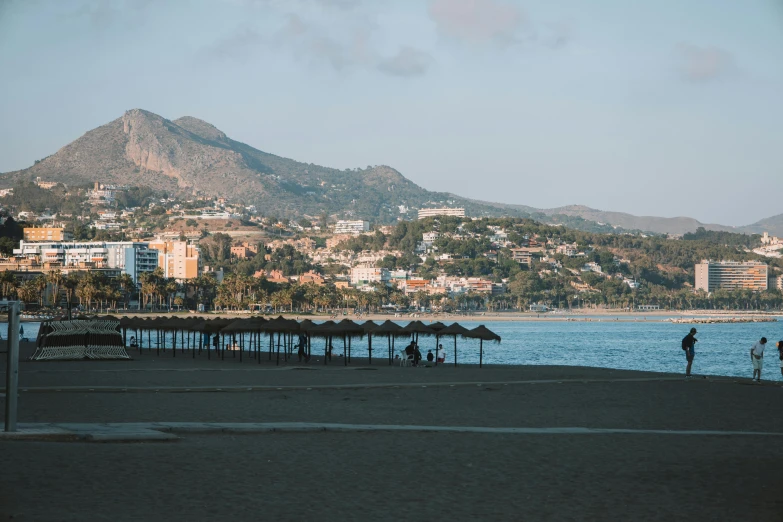 some people stand in front of the ocean as they walk