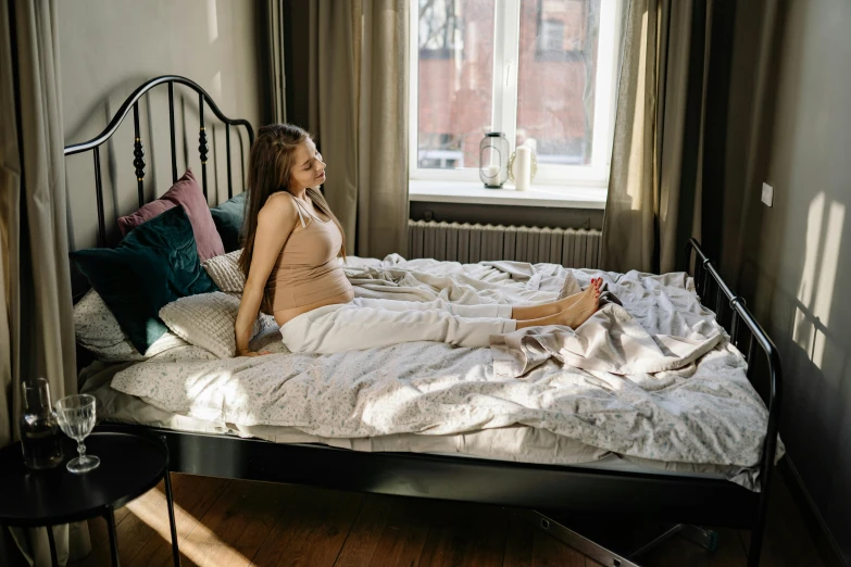 a woman in lingerie laying on a bed looking at the side