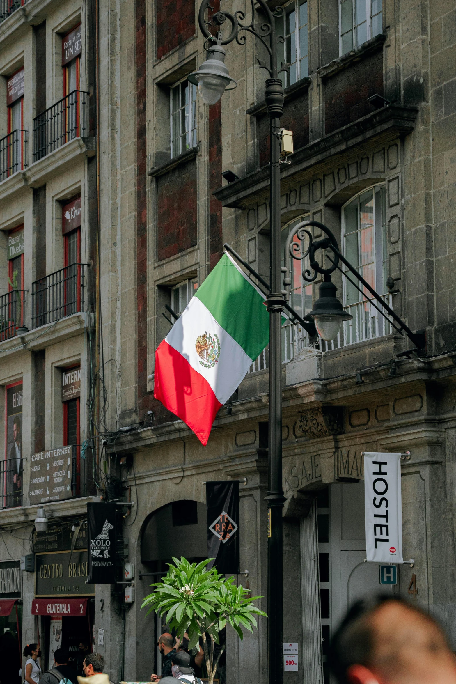 an italian flag is being flown outside a building