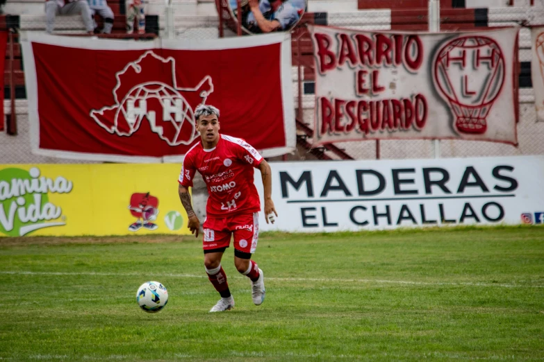 a young soccer player with red jersey on
