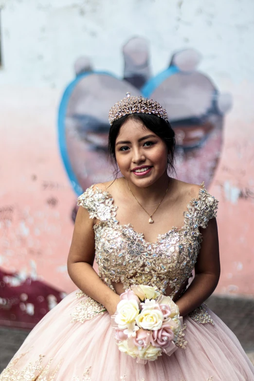 a woman is dressed in a pink ball gown