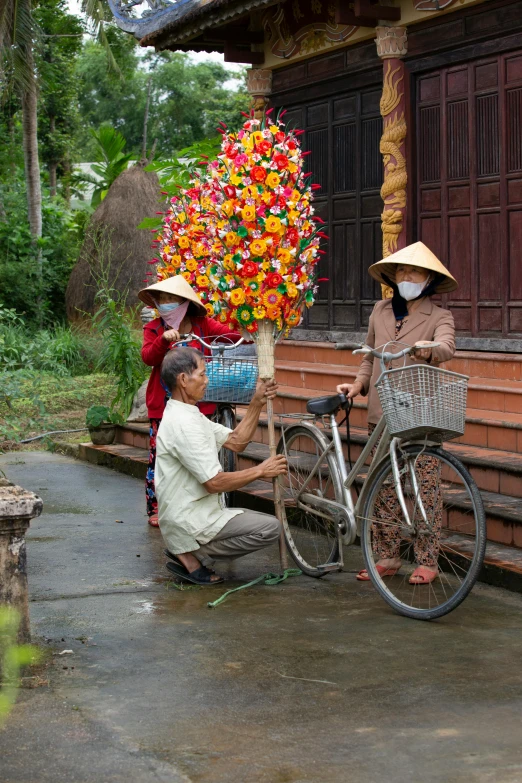 people stand on a bridge near an open air building