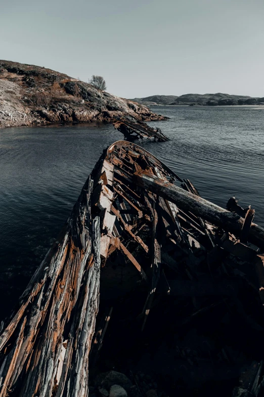 an old rusted boat is sitting in the water