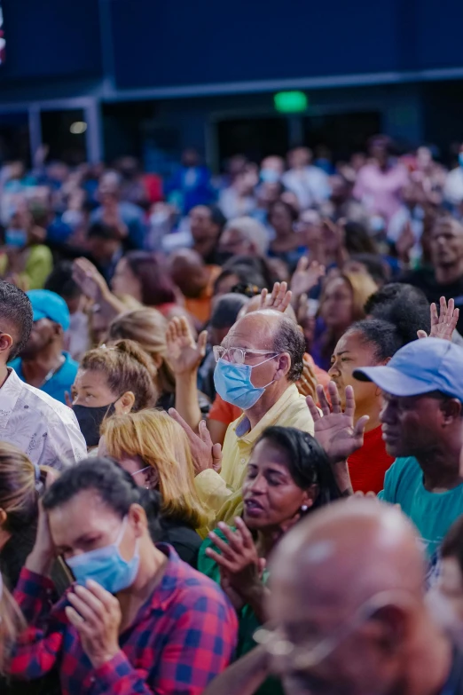 people wearing face masks and praying together