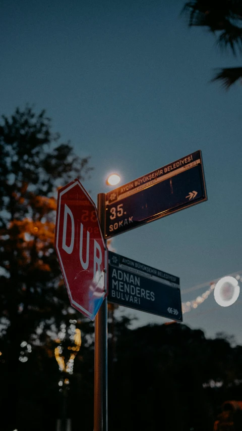 a stop sign on an urban corner at dusk
