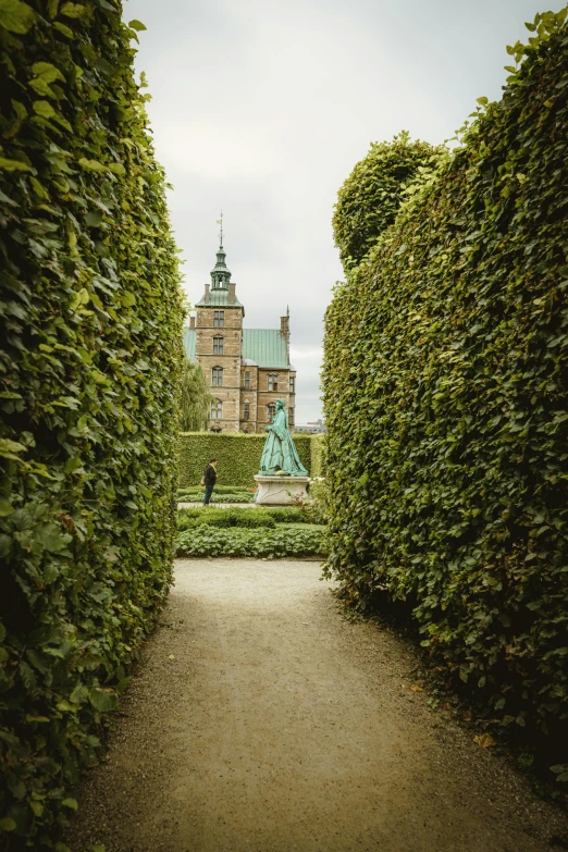 the tower of a building rises above an outdoor pathway