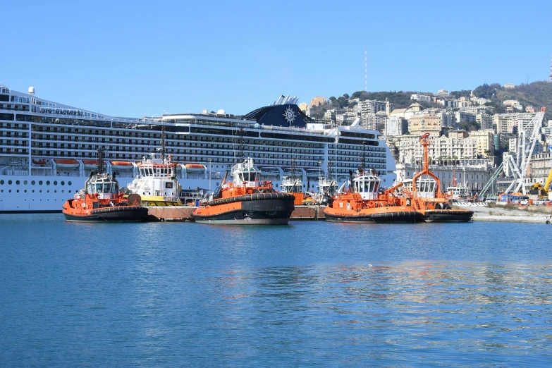 a number of ships in the water near a big city