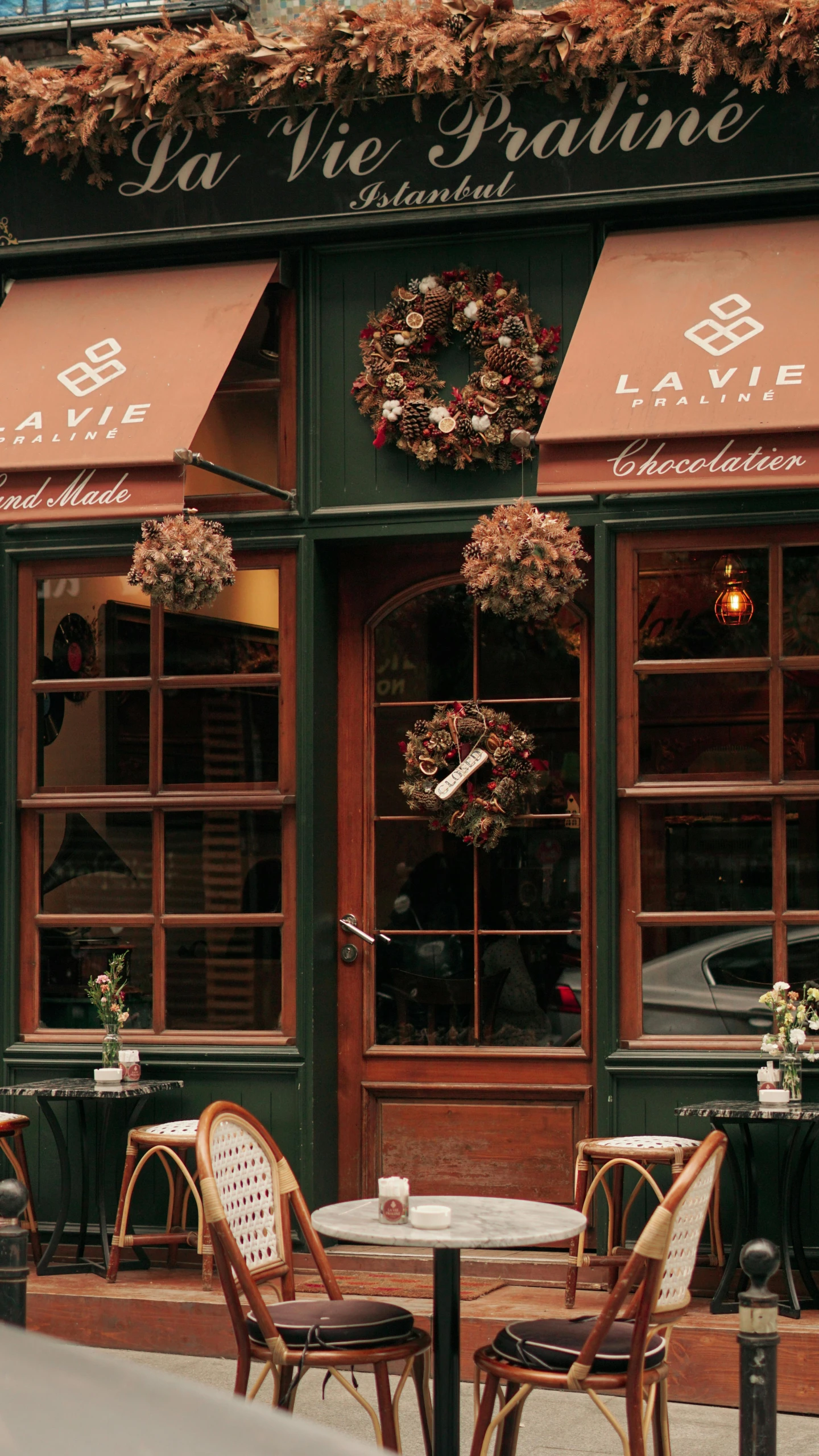 an outside cafe with tables and chairs in front